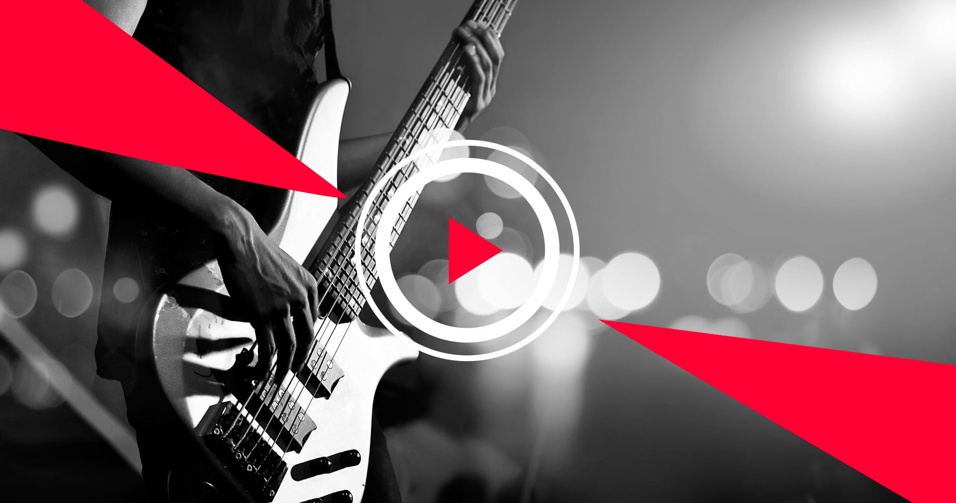 Electric bass guitarist performing onstage with graphics