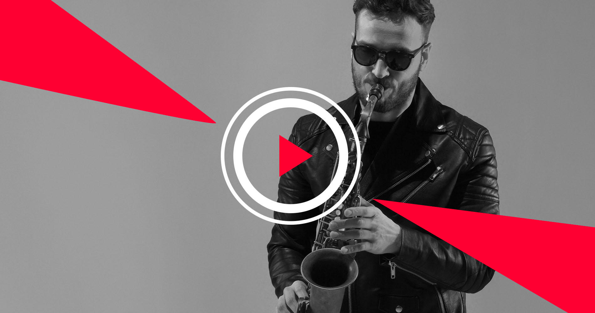 Man wearing sunglasses and leather jacket playing saxophone