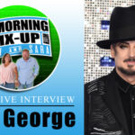 Interview poster with man wearing black hat