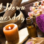 Relaxing spa scene: candle, essential oil, towel